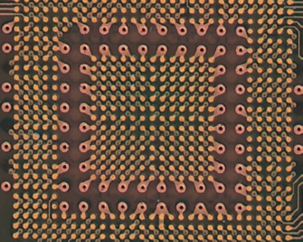 Dense PCB pad close-up | GlobalWin Close-up of dense copper pads and small via openings on a circuit board