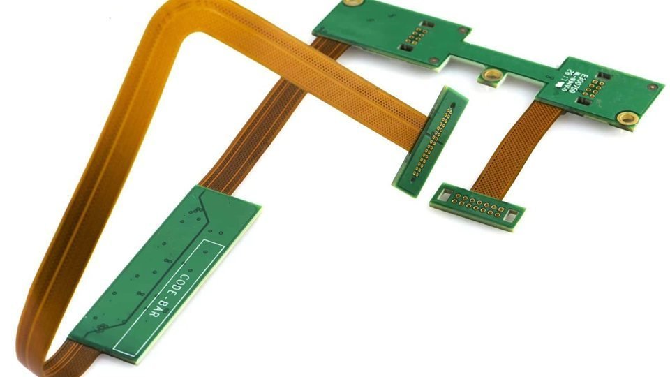 Green rigid circuit sections joined by folded amber flexible connections