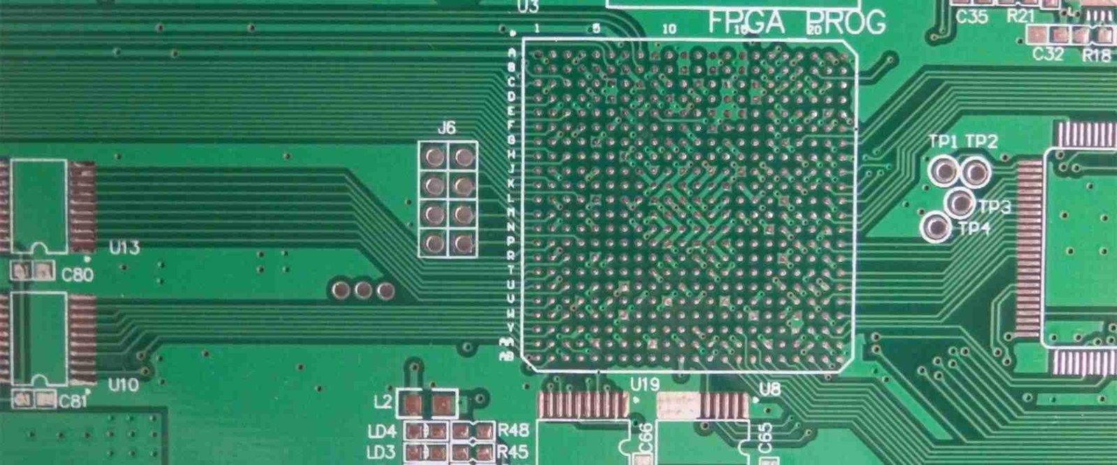 Dense circuit-board footprint | GlobalWin Close-up of a large grid of contact pads and surrounding copper traces on a green board