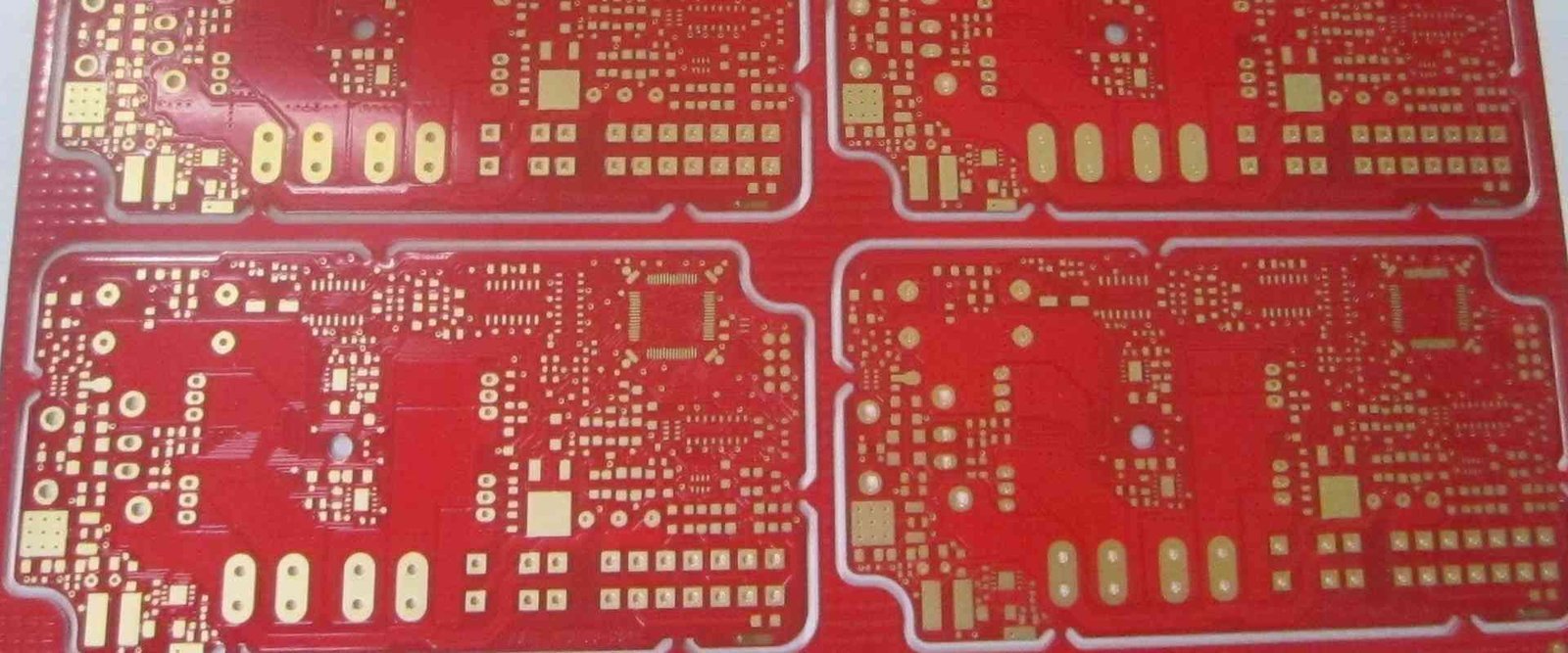 Red PCB panel | GlobalWin Red bare circuit-board panel with repeated circuit patterns and contact pads