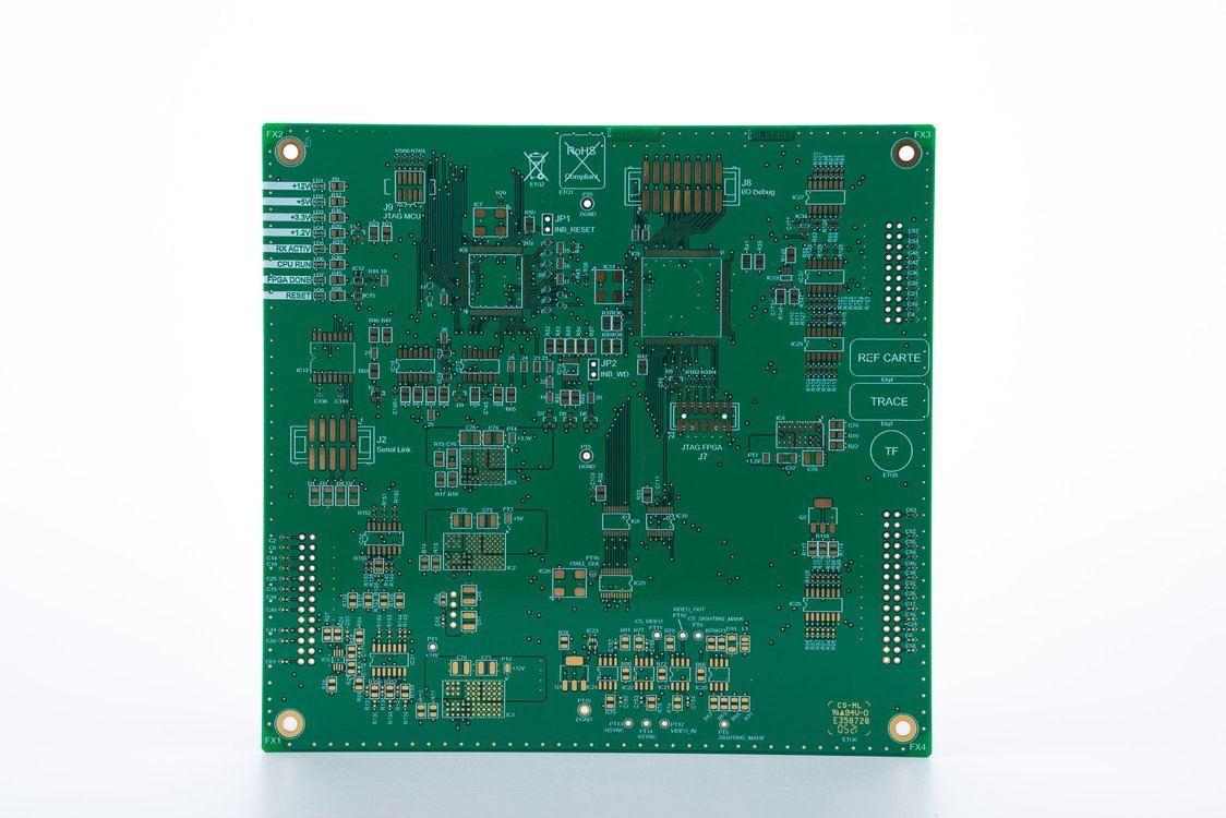 Unpopulated green printed circuit board with fine-pitch pads, copper traces and mounting holes