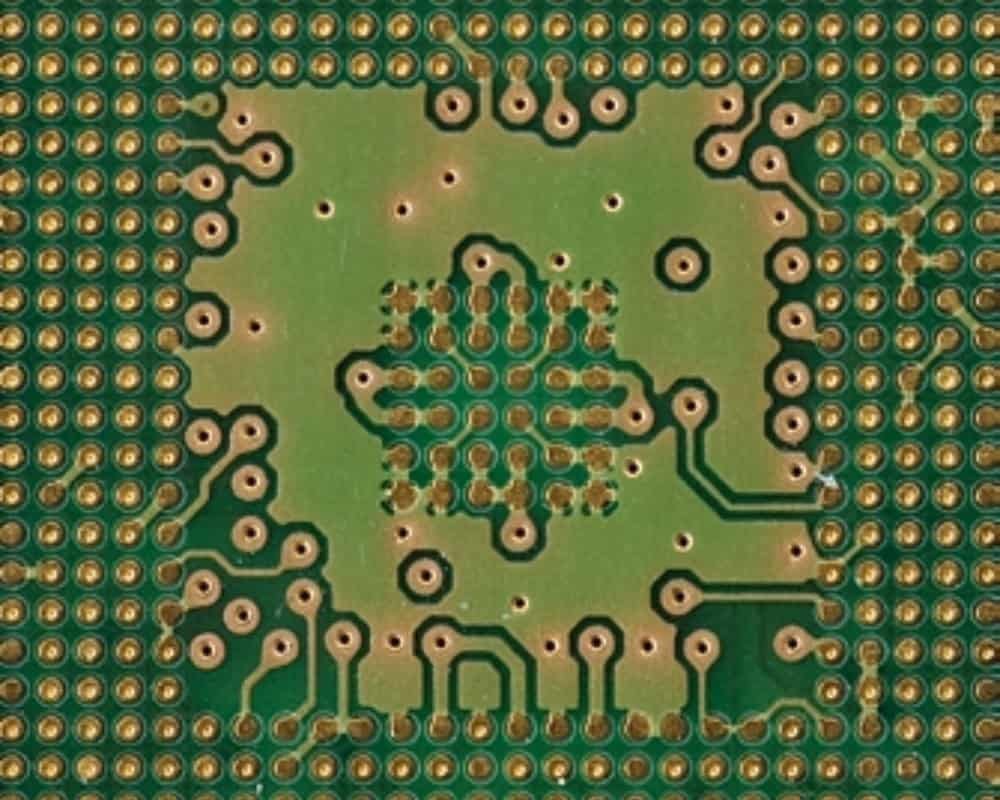 Small via and trace array | GlobalWin Close-up of small circuit-board via openings connected by fine copper traces