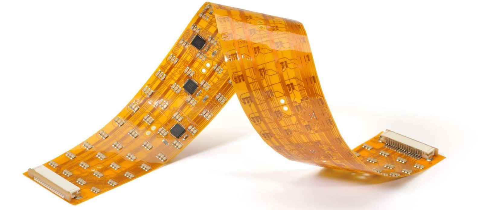 Bent flexible circuit | GlobalWin Amber flexible circuit folded into a bend with visible traces and components